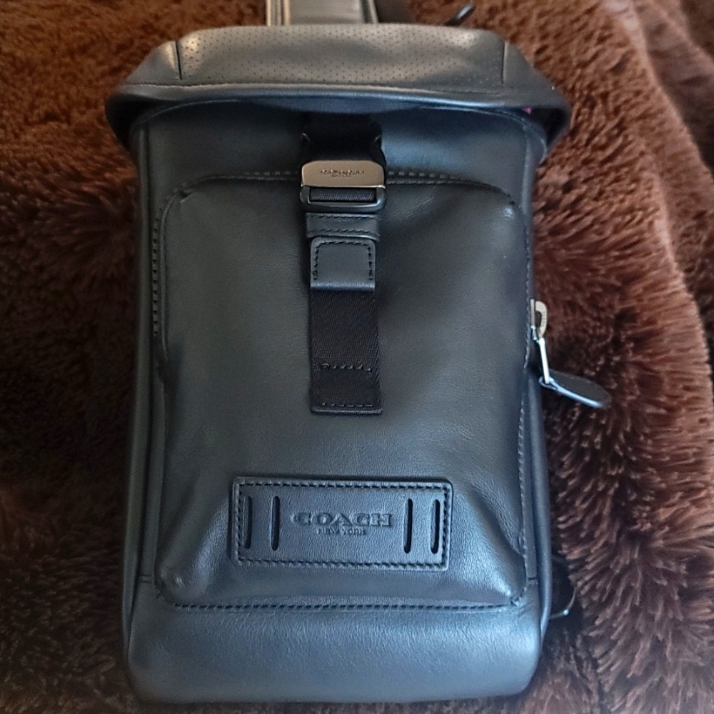 Coach sling trekker backpack.